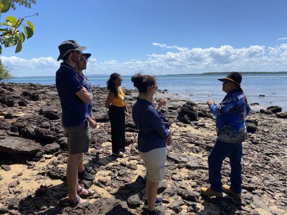 SUSMB team members on the shore at Polka Point, listening to Uncle Norm
