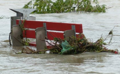 stormwater rises around a park bench