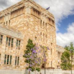 Students sit outside the Forgan Smith Building